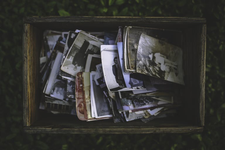 A nostalgic collection of vintage photos in an old wooden box.