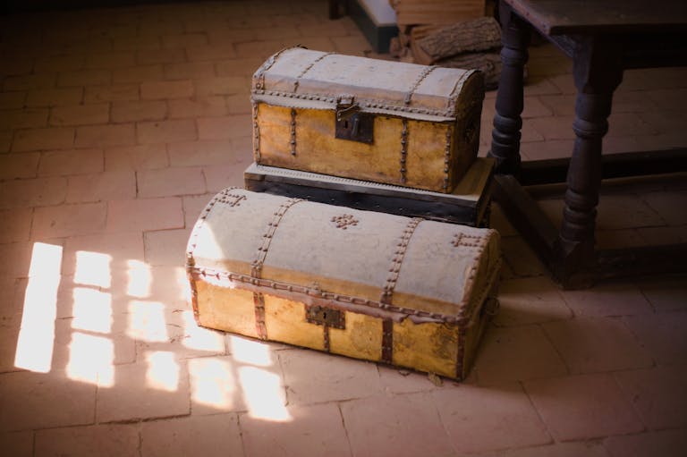 Old wooden chests bathed in soft sunlight in a vintage setting.