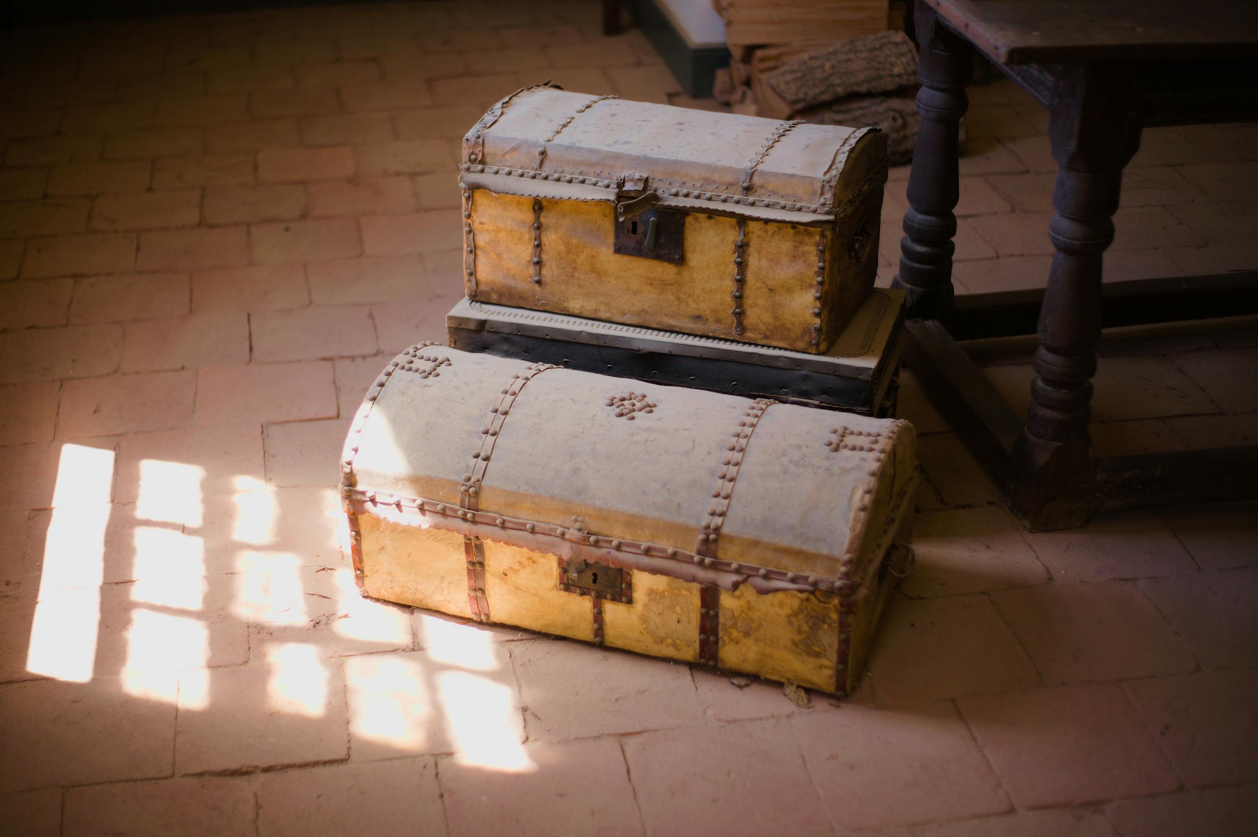 Old wooden chests bathed in soft sunlight in a vintage setting.